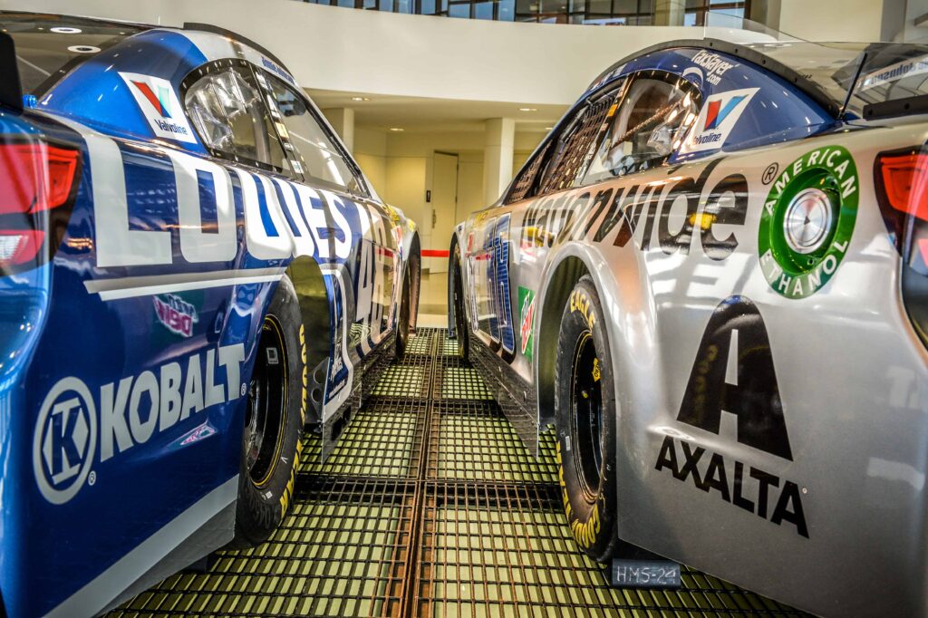 Race cars sit side by side at Hendrick Motorsports.