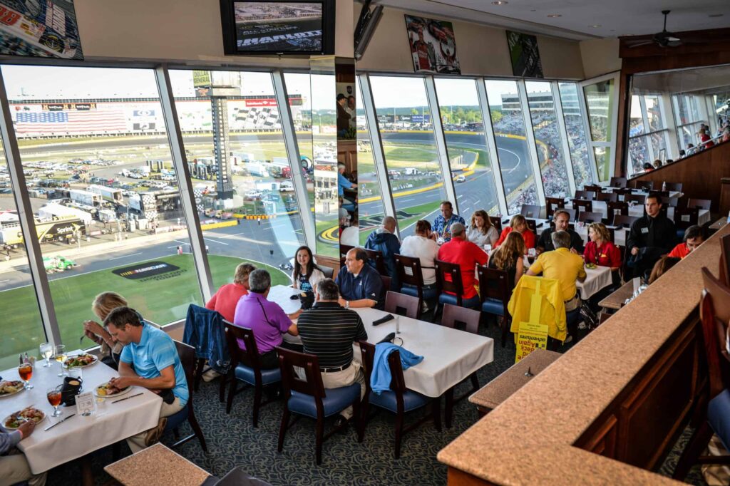 people sitting in restaurant overlooking race track