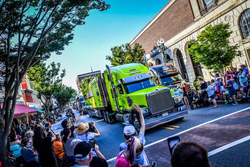 Fans wave and cheer as NASCAR haulers parade through Downtown Concord during the Haulers on Union Parade