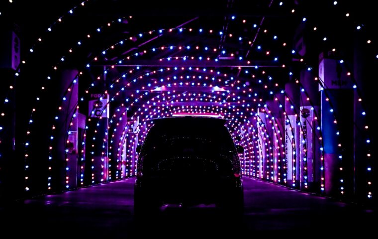 SUV driving through holiday lights