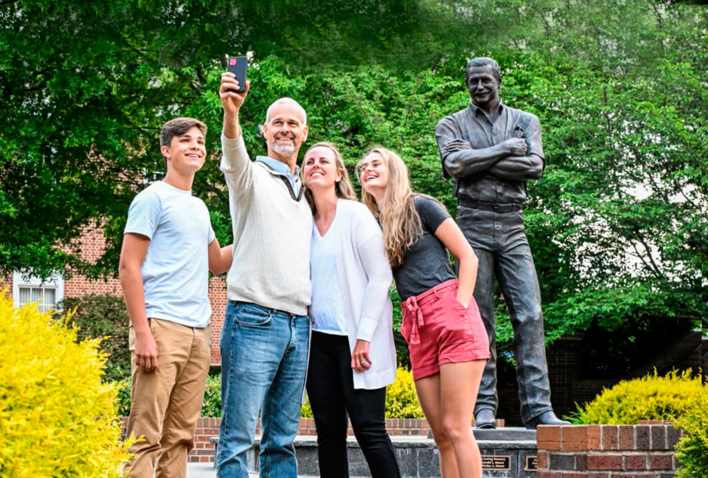 family poses in front dale earnhardt statue