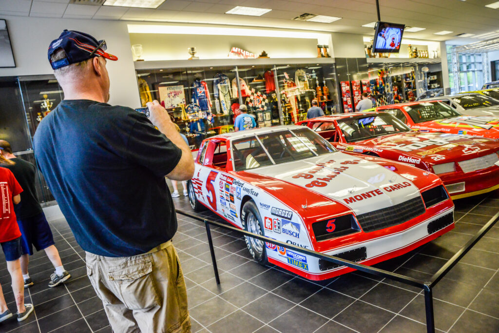race fan taking photo of car on display