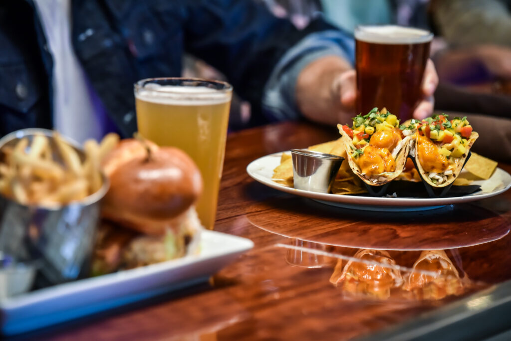 plates of food and beer glasses on table