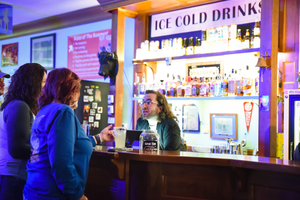 Bartender takes an order from customers