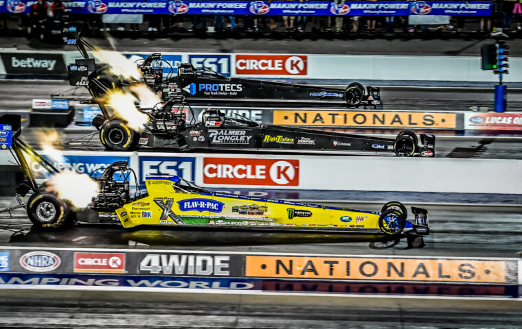 dragsters racing four-wide on track