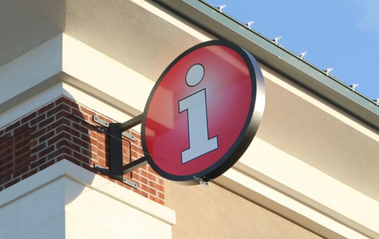 "i" information sign on visitor center exterior