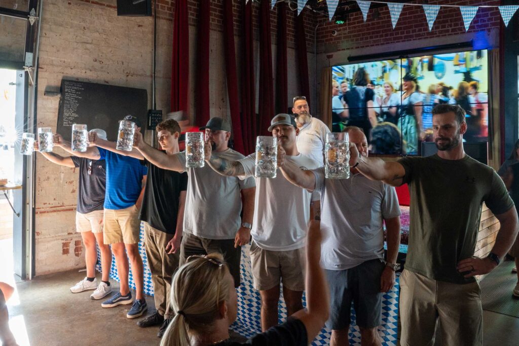 group of men holding steins