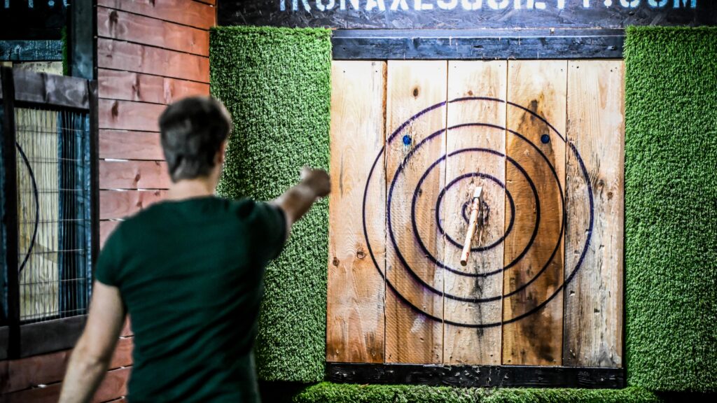 man throws axe at target