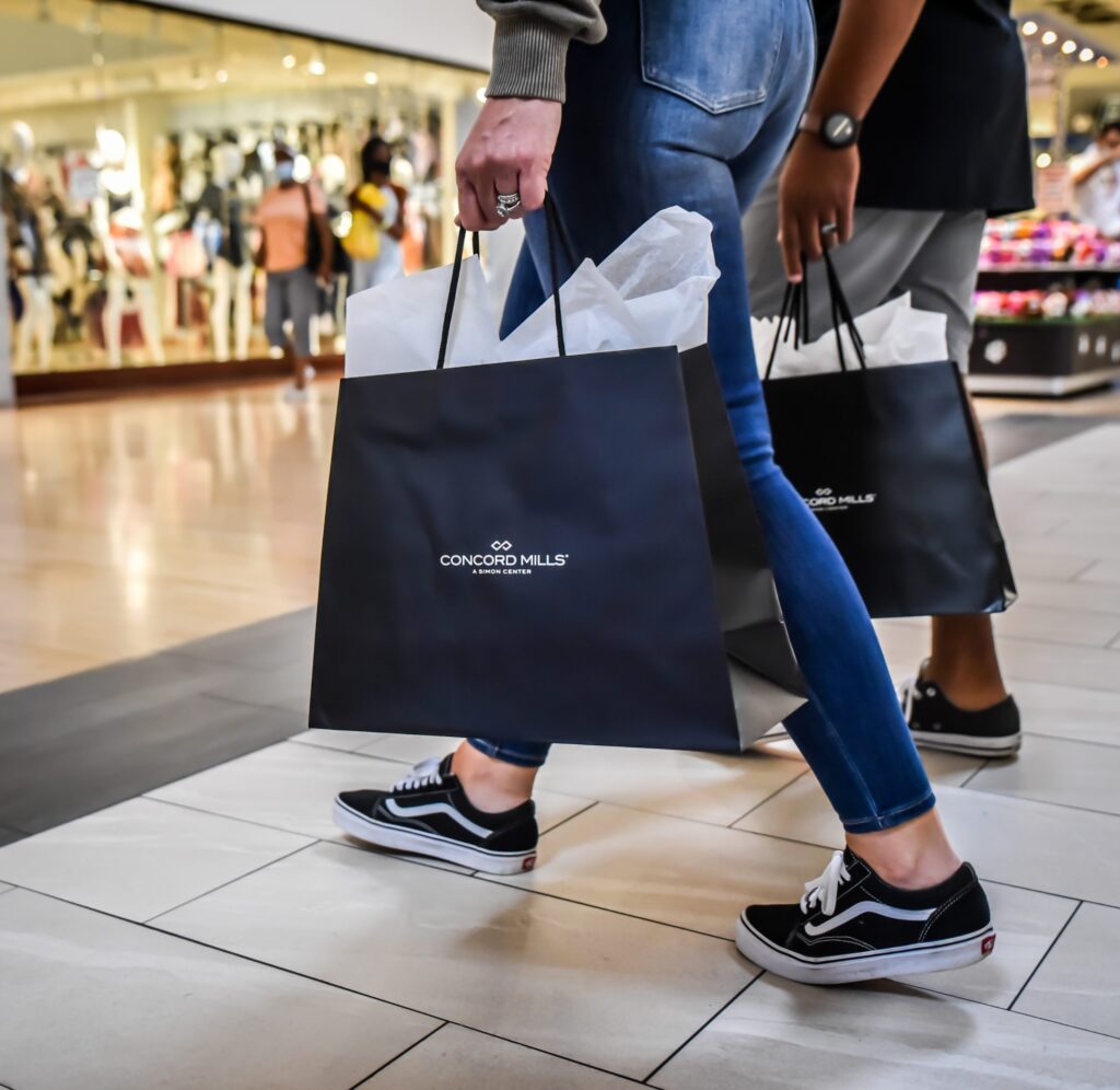 Shoppers carrying bags at a mall